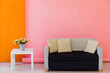 Pink orange room interior with grey office sofa and flowers