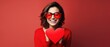 Portrait of a happy woman with red heart on a red background.Valentine's Day Concept