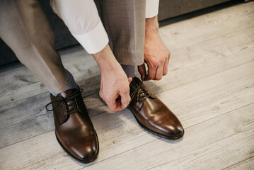 the man wears brown leather shoes