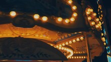 A Carousel Or Carrousel, Merry-go-round, Roundabout, Or Hurdy-gurdy Is Amusement Ride Consisting Of A Rotating Circular Platform With Horse Seat For Riders. Colorful Flashing Light Of Vintage Carnival