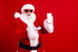 © deagreez - Photo of elderly retired funky man santa claus arm demonstrate display empty space new year offer advert isolated on red color background