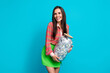 Photo portrait of pretty young girl hold money jar bank account deposit wear trendy green skirt isolated on cyan color background