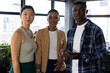 © Wavebreak Media - Portrait of three diverse male and female casual business colleagues standing in office, copy space