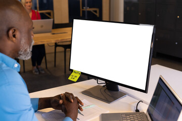 Senior african american casual businessman having video call at desk with copy space computer screen