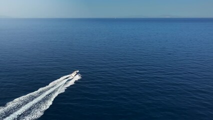 Wall Mural - high aerial view of a motor boat cruising alone with high speed over the blue ocean