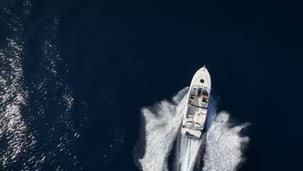 Wall Mural - aerial top down tracking view of a motorboat cruising overthe ocean with high speed