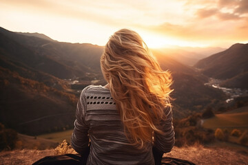 Wall Mural - Rear view of female contemplating scenic view of raw nature from above during sunset, aesthetic look