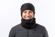 Portrait of a smiling man in his 40s wearing a protective neck gaiter against a white background. AI Generation