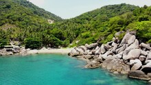 Panning From Right To The Left Side Of The Frame On A Secluded Rocky Beachfront Of Ao Hin Wong, A Scenic Bay With Crystal Blue Waters On The East Side Of Koh Tao Island In Thailand