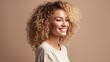 © Hope - Smiling young woman with blonde curly groomed hair isolated on pastel flat background with copy space. Blonde hair care products banner template, hair salon.