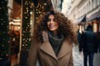 © Hope - Portrait of happy woman on city street looking at camera. Beautiful girl standing outdoors in winter evening with a toothy smile. Cheerful university student wearing coat with woolen scarf at dusk.