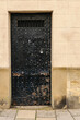 Heavy steel door on the outside of a traditional prison lock-up in an English town.
