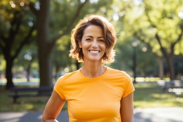 Canvas Print - Portrait of a grinning woman in her 40s dressed in a casual t-shirt against a vibrant city park. AI Generation