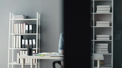 Wall Mural - Asian woman sitting in office, businesswoman in finance and accounting is working, collecting financial documents to summarize financial statements, profit and loss statement, accounting concept.