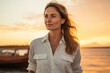 © CogniLens - Portrait of a content woman in her 30s sporting a vented fishing shirt against a vibrant beach sunset background. AI Generation