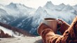 © Oulaphone - Hands woman holding hot drink cup relaxes in winter season with mountain view background.