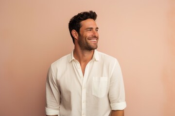 Portrait of a blissful man in his 30s wearing a simple cotton shirt against a pastel or soft colors background. AI Generation