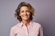© CogniLens - Portrait of a jovial woman in her 40s sporting a technical climbing shirt against a pastel or soft colors background. AI Generation