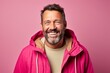 Portrait of a grinning man in his 40s dressed in a water-resistant gilet against a pastel or soft colors background. AI Generation