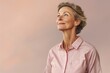 Portrait of a tender woman in her 50s sporting a breathable hiking shirt against a pastel or soft colors background. AI Generation