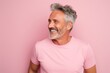 Portrait of a blissful man in his 50s donning a trendy cropped top against a pastel or soft colors background. AI Generation