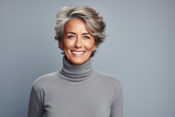 Poster - Portrait of a smiling woman in her 60s wearing a classic turtleneck sweater against a minimalist or empty room background. AI Generation