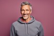 Portrait of a glad man in his 50s dressed in a comfy fleece pullover against a solid color backdrop. AI Generation