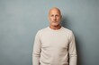 © CogniLens - Portrait of a glad man in his 50s sporting a long-sleeved thermal undershirt against a plain cyclorama studio wall. AI Generation