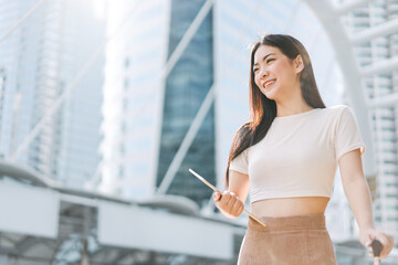 Freelance young asian beautiful woman walking with travel luggage for business trip in the city