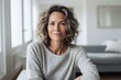 © CogniLens - Portrait of a glad woman in her 40s wearing a cozy sweater against a crisp minimalistic living room. AI Generation