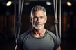 © Markus Schröder - serious mature man doing aerial yoga in a studio