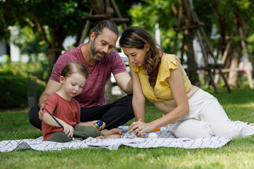 Wall Mural - Happy family day, father, mother, son, Caucasian enjoying watercolor painting and picnic in nature.