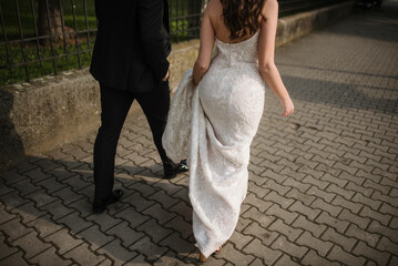 Wall Mural - Bride and groom. Just married. Happy couple walking away.