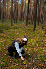 girl in the wood looking for a mushrooms