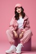 © VERTEX SPACE - full body portrait shot of stylish young asian teen in sport jacket wear fashion pose shooting sit against pink wall color backdrop portrait concept