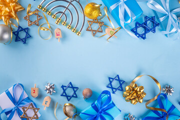 Happy Hanukkah greeting card background. Jewish New Year holiday flat lay with traditional symbols of hanukkah festival, menorah, donuts and decorations copy space