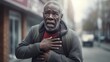  Senior black male stands bent over on the city street and holds his hand to his chest, felt severe pain and spasm in his heart, generative ai.