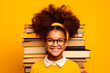 African American girl holding books full of happiness because school is starting. back to school. on yellow background. concept of learning by playing