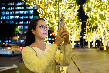 Poster - Woman use cellphone to take photo in the city