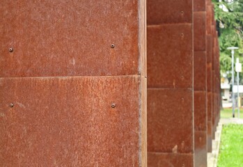 Wall Mural - Detail of a colonnade cladded with corten steel. Background and texture.