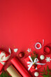 canvas print picture - Christmas Present box and decorations at red background. Wrapping christmas present. Vertical.