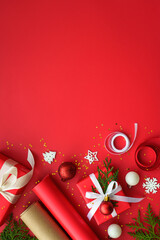 Wall Mural - Christmas Present box and decorations at red background. Wrapping christmas present. Vertical.