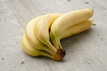 Canvas Print - Ripe bananas bunch on the concrete background