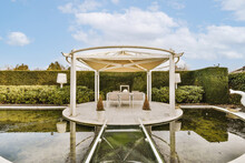 Dining Table In Gazebo Surrounded By Pool