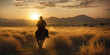 With the sun sinking behind the mountains, a cowboy on horseback, his lasso at the ready, rides through the desert landscape