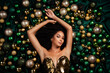 High angle top portrait of stunning lady posing lying on emerald silky texture background decorated with xmas baubles