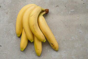 Poster - Ripe bananas bunch on the concrete background