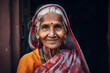© ADDICTIVE STOCK - AI Generated Image of smiling Indian senior elderly woman wearing traditional sari and accessories looking at camera while standing against dark background
