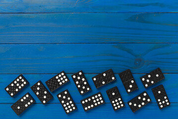 Wall Mural - Black domino tiles on wooden background, top view