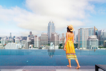 Wall Mural - Asian traveller woman sleep and relax at swimming pool